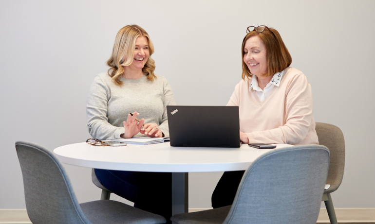 Women working together at a laptop